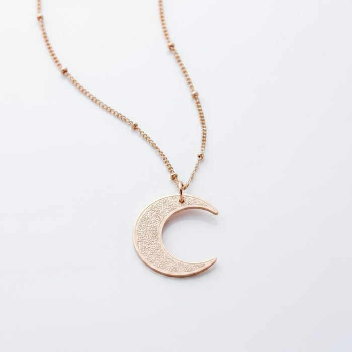 Ayatul Kursi necklace crescent with a shiny crescent pendant on a delicate chain.