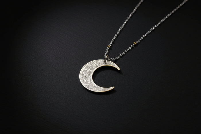 Ayatul Kursi necklace crescent with intricate designs on a silver crescent pendant.