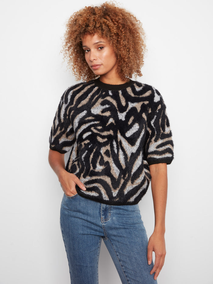 Stylish sweater featuring a mock neck, perfect for cozy days. The unique pattern adds flair to any outfit by Charlie B.