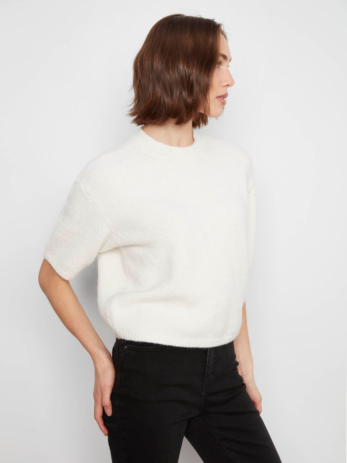 Mock neck adds a touch of sophistication to this versatile piece by Charlie B.