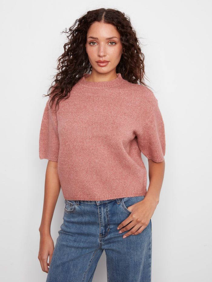 This knit top features a stylish mock neck, adding elegance to any outfit. Perfect for layering or wearing alone by Charlie B.