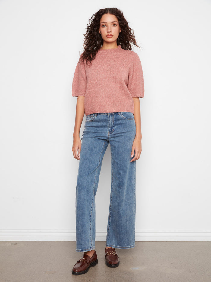 A chic addition to any closet, this knit top combines fashion-forward design with timeless appeal by Charlie B.