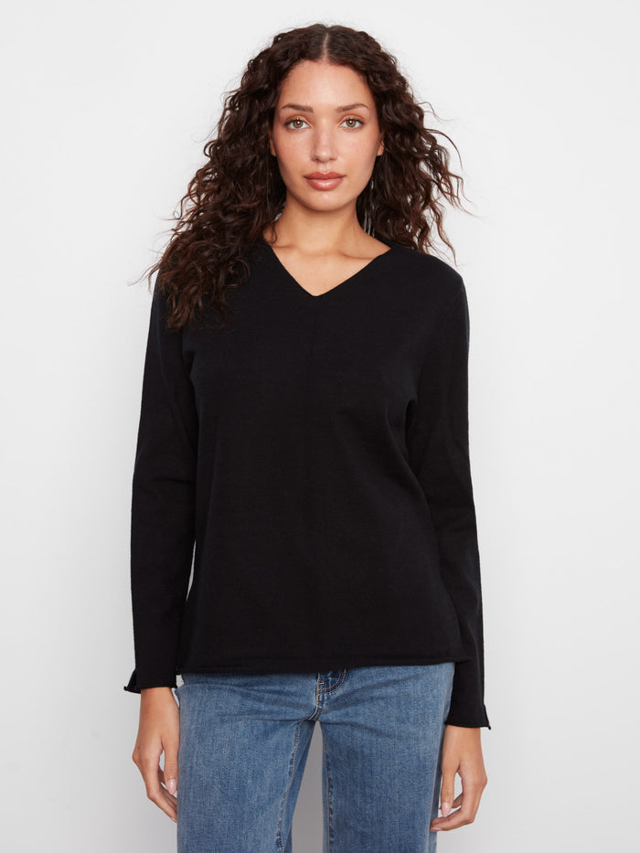 Black V-neck sweater featuring side slits for a modern touch by Charlie B.