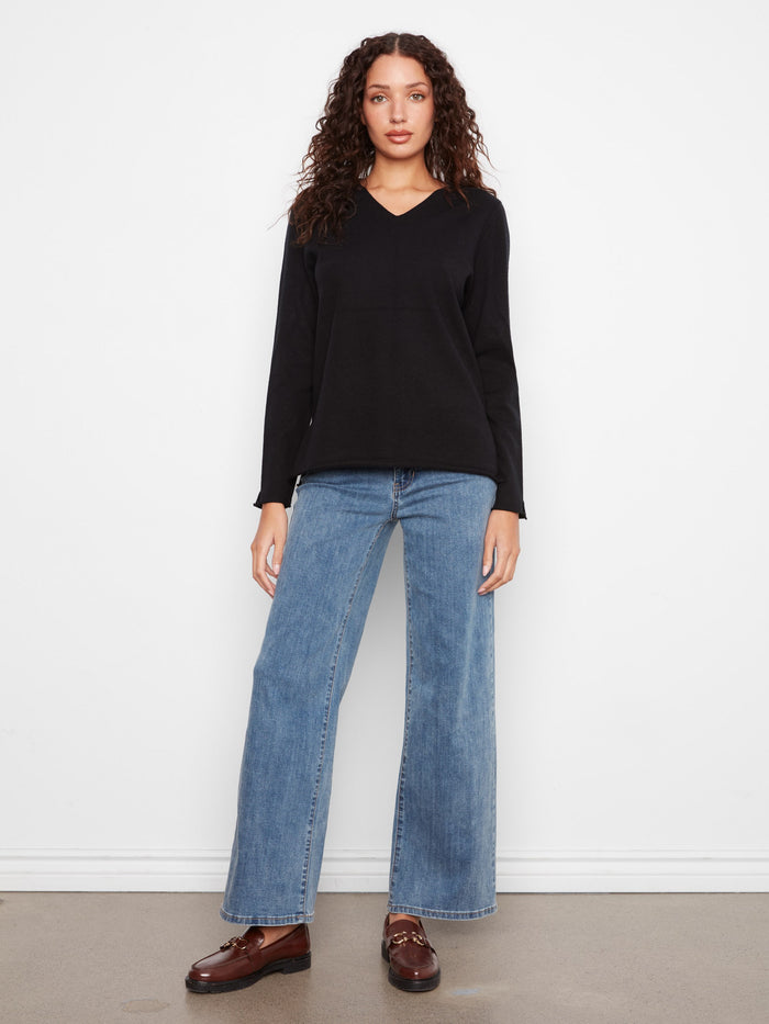 Long sleeve black sweater with a classic V-neckline and timeless appeal by Charlie B.