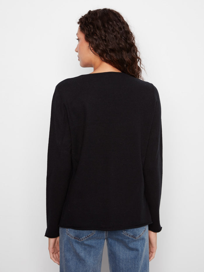 Chic black sweater designed with long sleeves and subtle side slits by Charlie B.