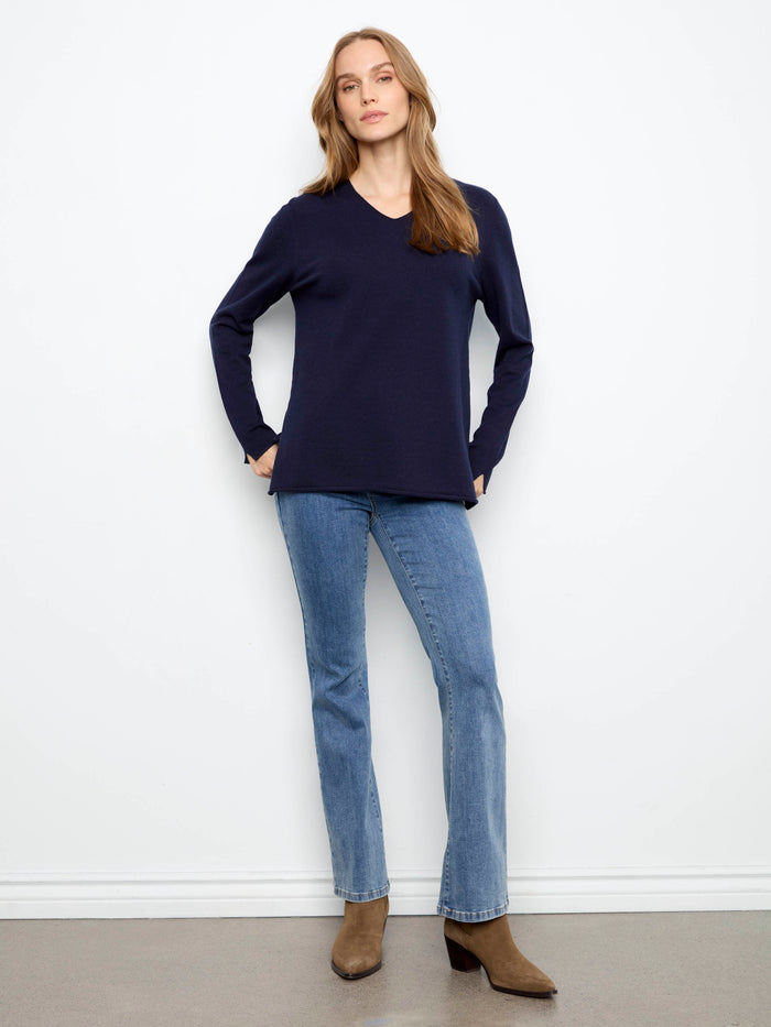 This elegant sweater boasts long sleeves, offering warmth and style for any occasion. By Charlie B.
