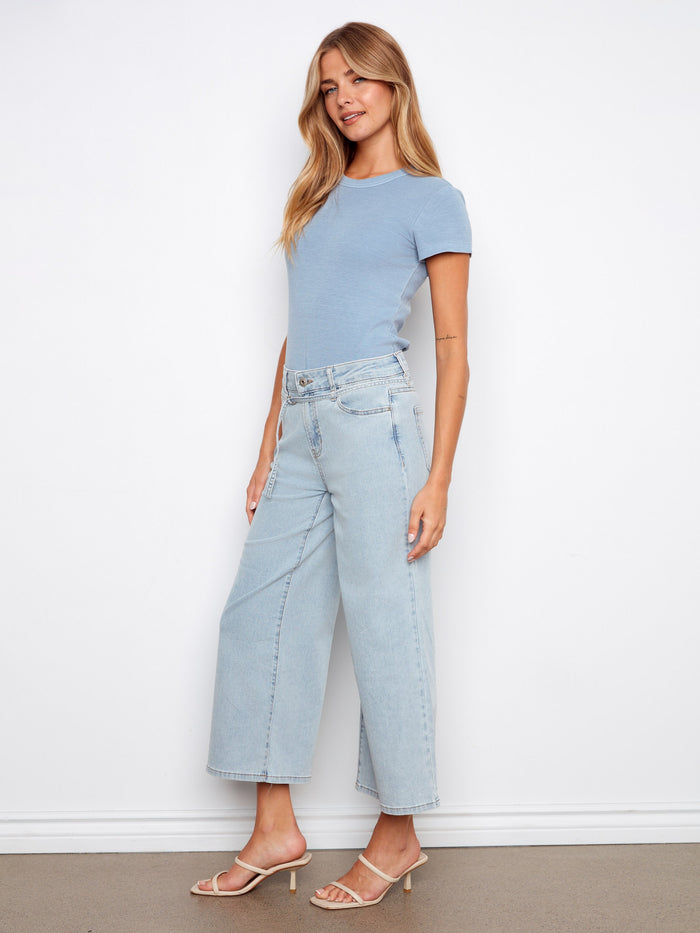 The belted design adds a touch of elegance to these versatile denim jeans by Charlie B.