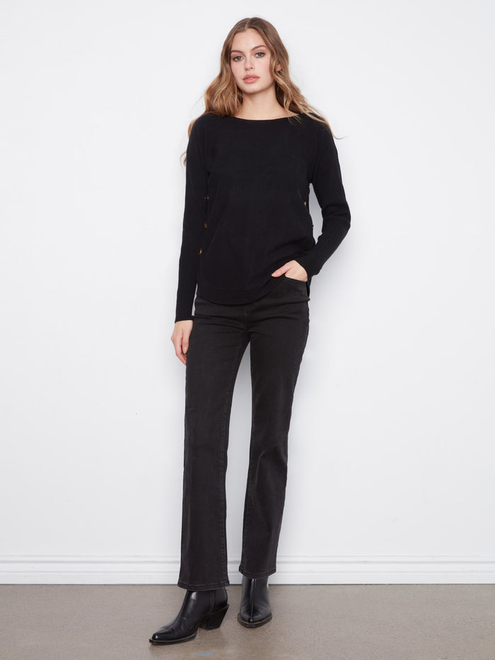 Chic black long-sleeve sweater with unique side button accents and rounded hem by Charlie B.