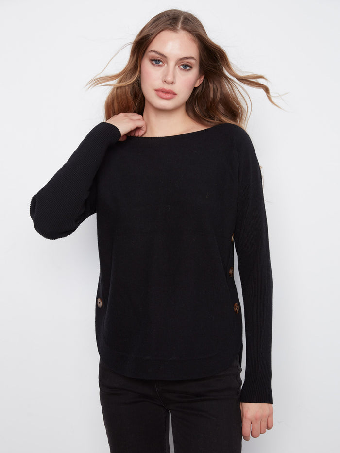 Elegant black sweater with a classic boat neck design, complete with ribbed sleeves by Charlie B.
