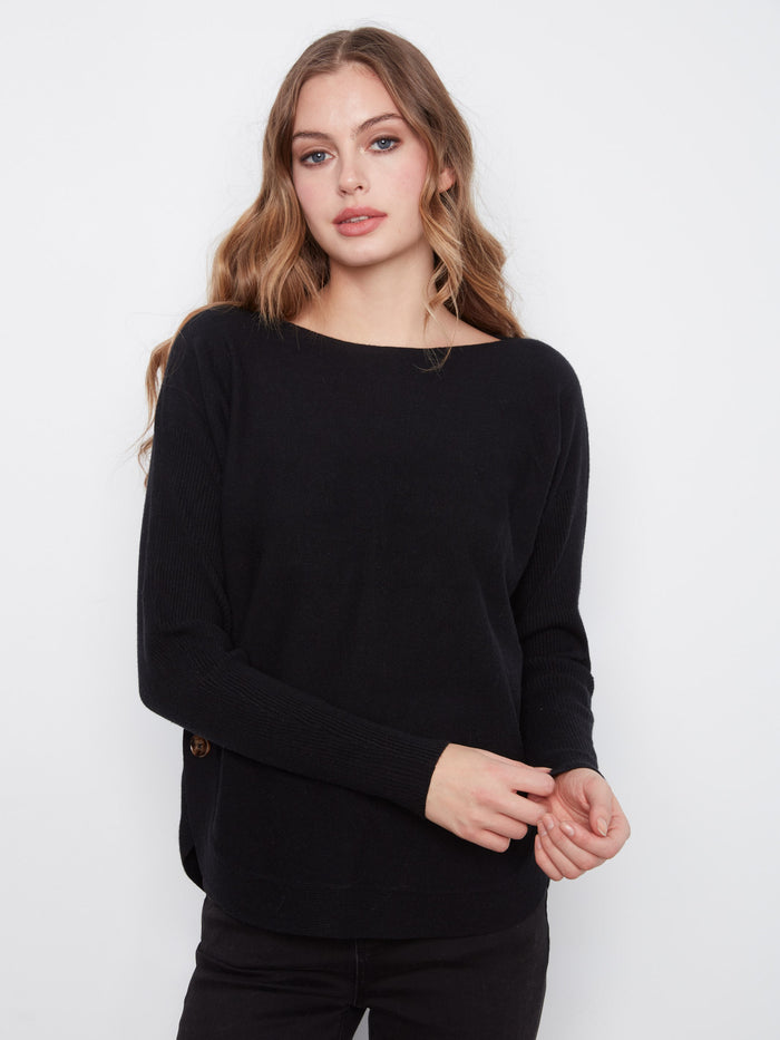 Sophisticated black sweater featuring a rounded hem and stylish side button detailing by Charlie B.