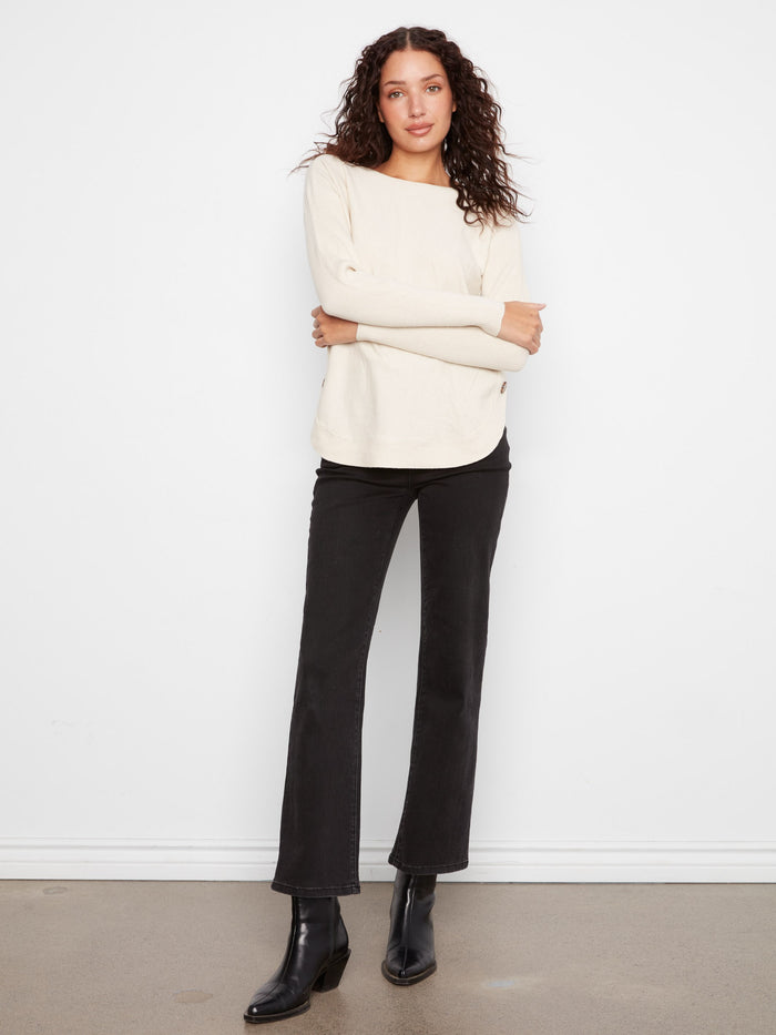 The rounded hem of this sweater provides a flattering silhouette, enhancing your everyday look with ease by Charlie B.