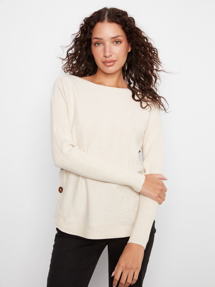 Enjoy the comfort and style of ribbed sleeves on this sweater, perfect for layering during cooler months by Charlie B.