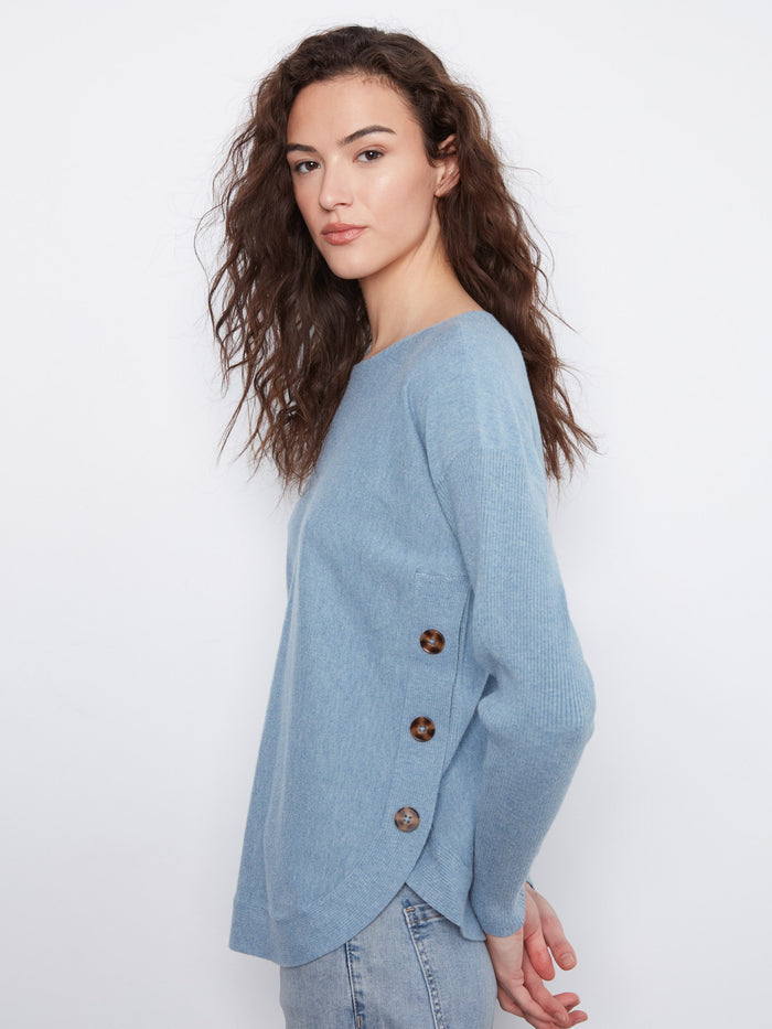 Stylish light blue top with rounded hem and elegant side buttons, adding flair to your wardrobe by Charlie B.