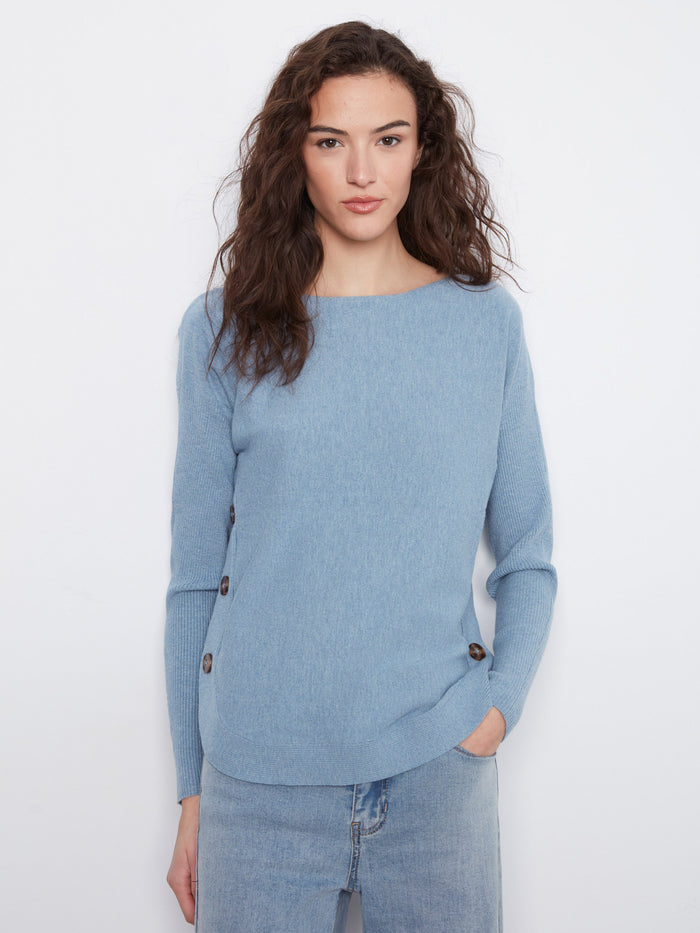 Elegant sweater in soft blue with distinctive boat neck design and charming button detail by Charlie B.