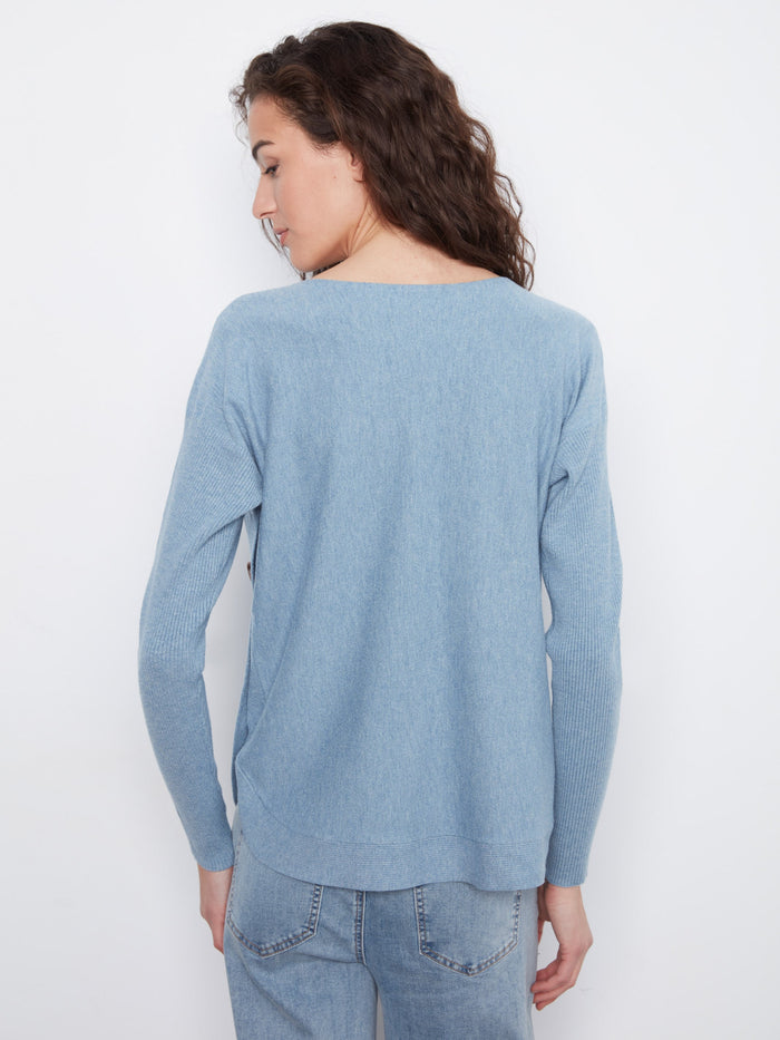 Comfortable blue knit top highlighting ribbed sleeves, perfect for layering or wearing solo by Charlie B.