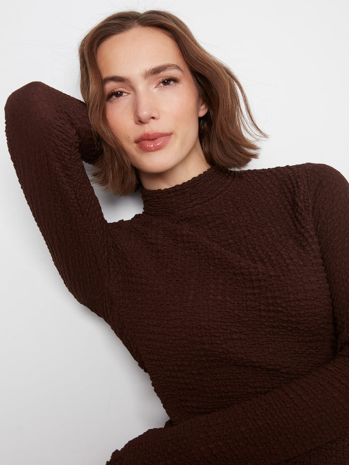 Chic lettuce-edge trim adds a playful touch to this slim fit top by Charlie B.