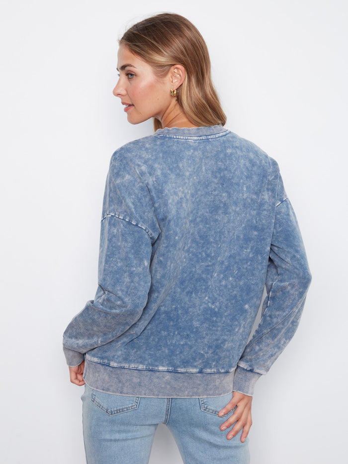 Stylish long sleeve terry top in denim blue with intricate flower embroidery accents by Charlie B.