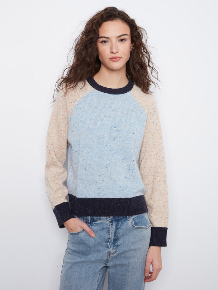 The sweater features a cozy crew neck design with a speckled knit pattern, perfect for casual outings. By Charlie B.