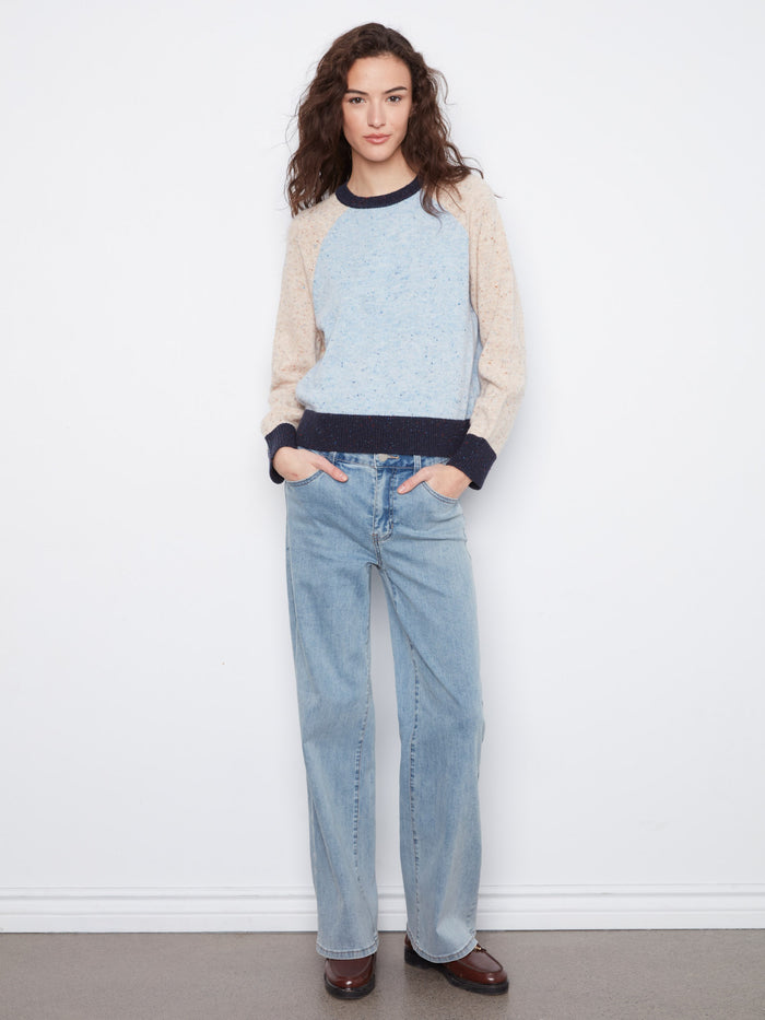 This stylish sweater showcases a contrast trim that adds an elegant touch to its overall look. By Charlie B.