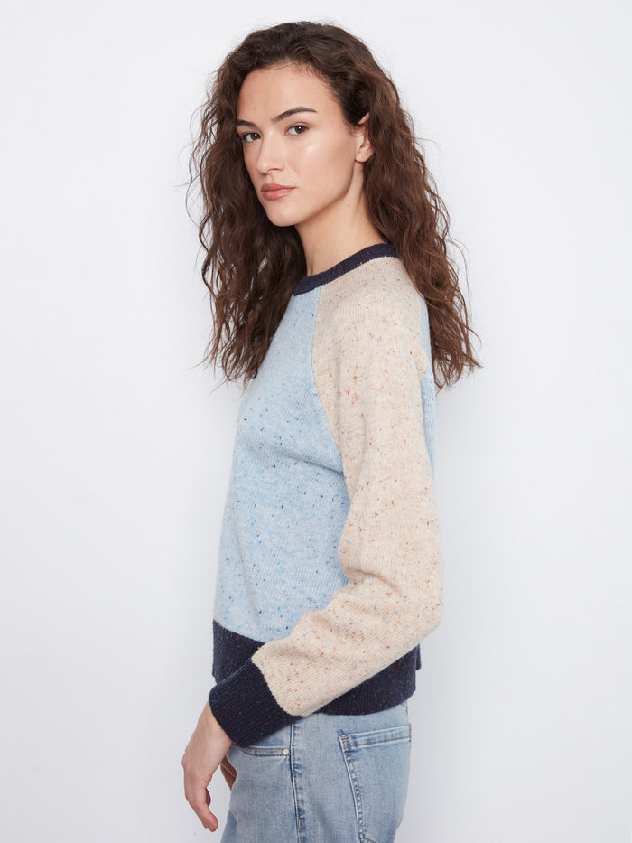 With its classic crew neck and contrast trim, this sweater combines timeless design with modern flair. By Charlie B.