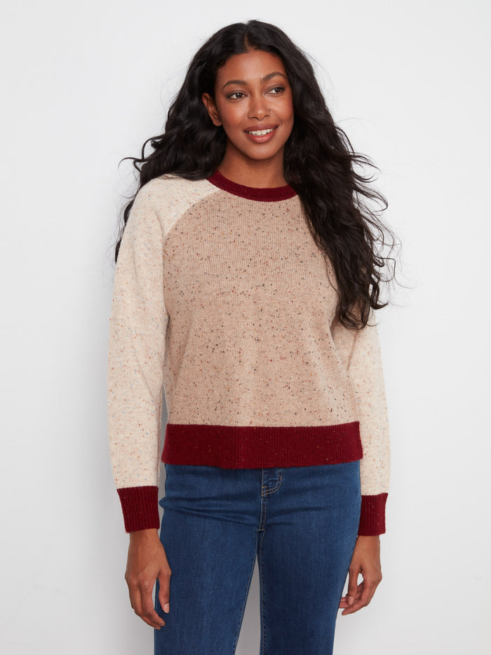 Warm-toned speckled knit sweater featuring a crew neck design with contrasting hem for added style by Charlie B.