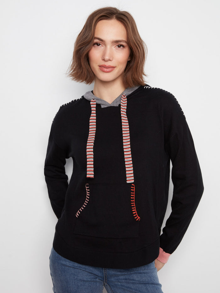 Black sweater with a kangaroo pocket and vibrant contrast stitching on the pocket edges by Charlie B.