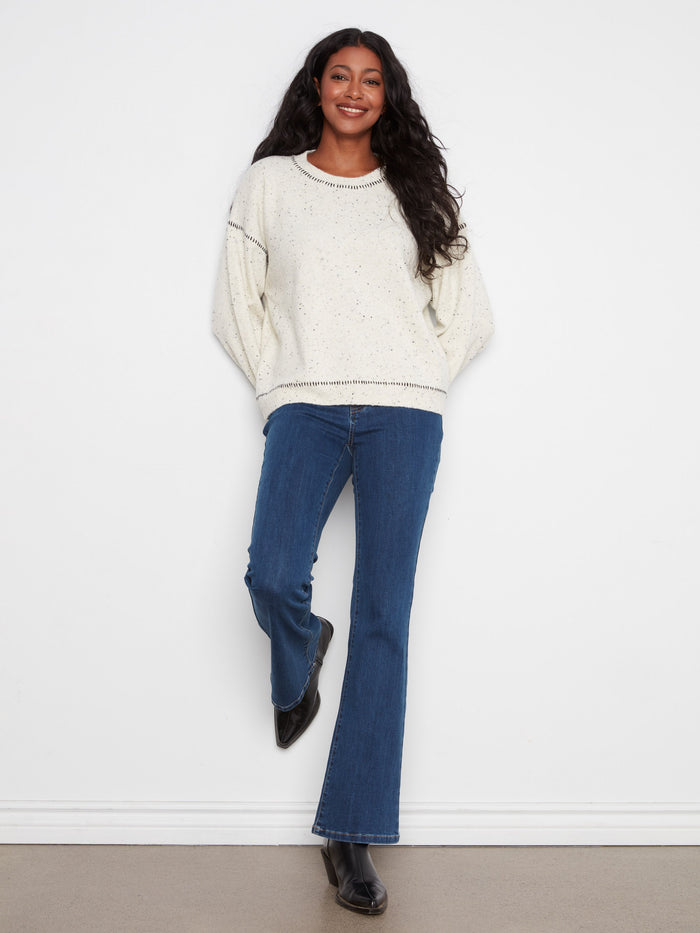 Whipstitch detailing adds a unique touch to this sweater, making it stand out in any wardrobe. Pair with jeans for effortless style by Charlie B.