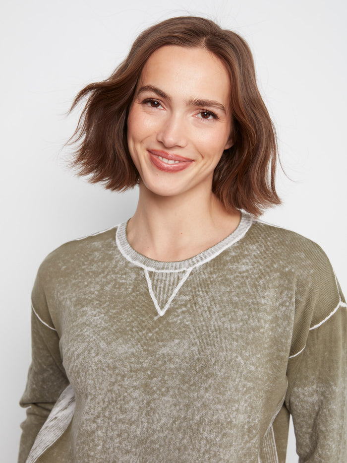 Elegant olive sweater crafted from 100% cotton, highlighted by its unique design details. Created by Charlie B.