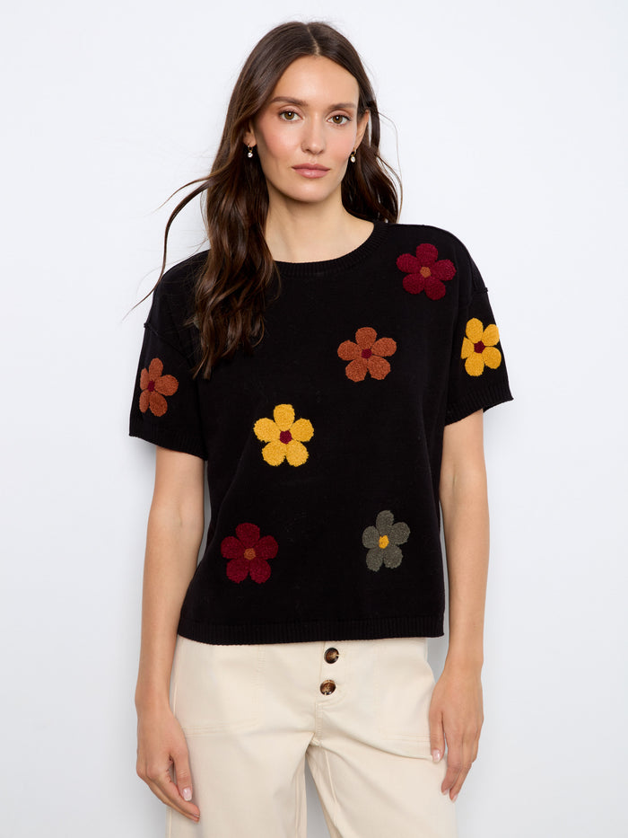 Elegant black short-sleeve sweater adorned with vivid floral embroidery and a classic crew neck by Charlie B.