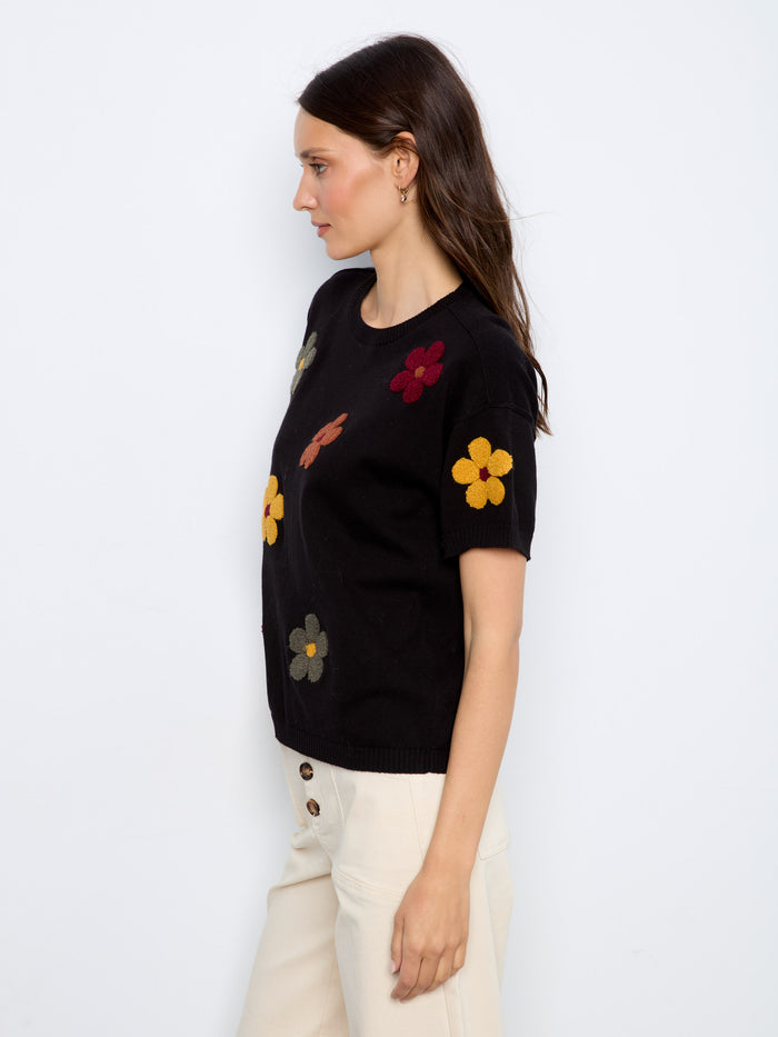 Stylish black top featuring vibrant floral designs and comfortable elbow-length sleeves by Charlie B.