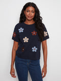 Navy top with a crew neck and floral design, made from soft 100% cotton for comfort. By Charlie B.
