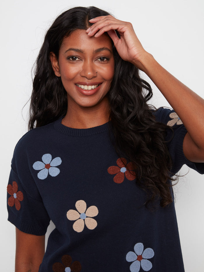 Chic navy top featuring elbow sleeves and colorful floral patterns, crafted from pure cotton. By Charlie B.