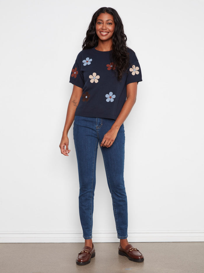 Stylish navy shirt in 100% cotton with vibrant flower designs, perfect for any casual look. By Charlie B.