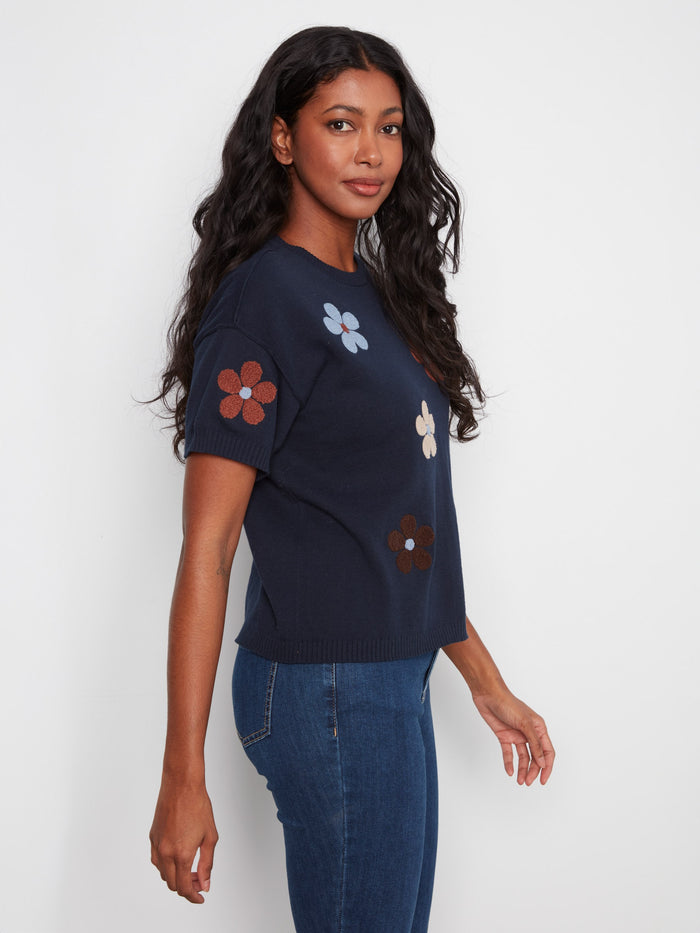Trendy navy garment showcasing colorful flowers on premium 100% cotton fabric for style. By Charlie B.