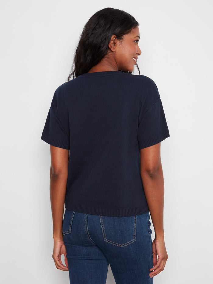 Classic navy piece with a crew neck design, adorned with delightful flower patterns in pure cotton. By Charlie B.