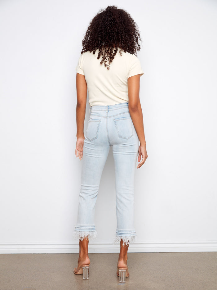 The frayed details add an edgy touch to these regular rise jeans, making them versatile for any occasion by Charlie B.