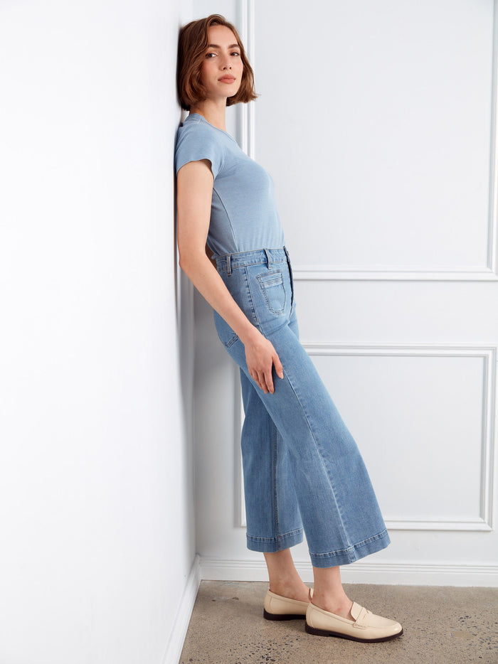 Flare fit design enhances the silhouette, paired with back pockets to combine fashion and practicality seamlessly. By Charlie B.