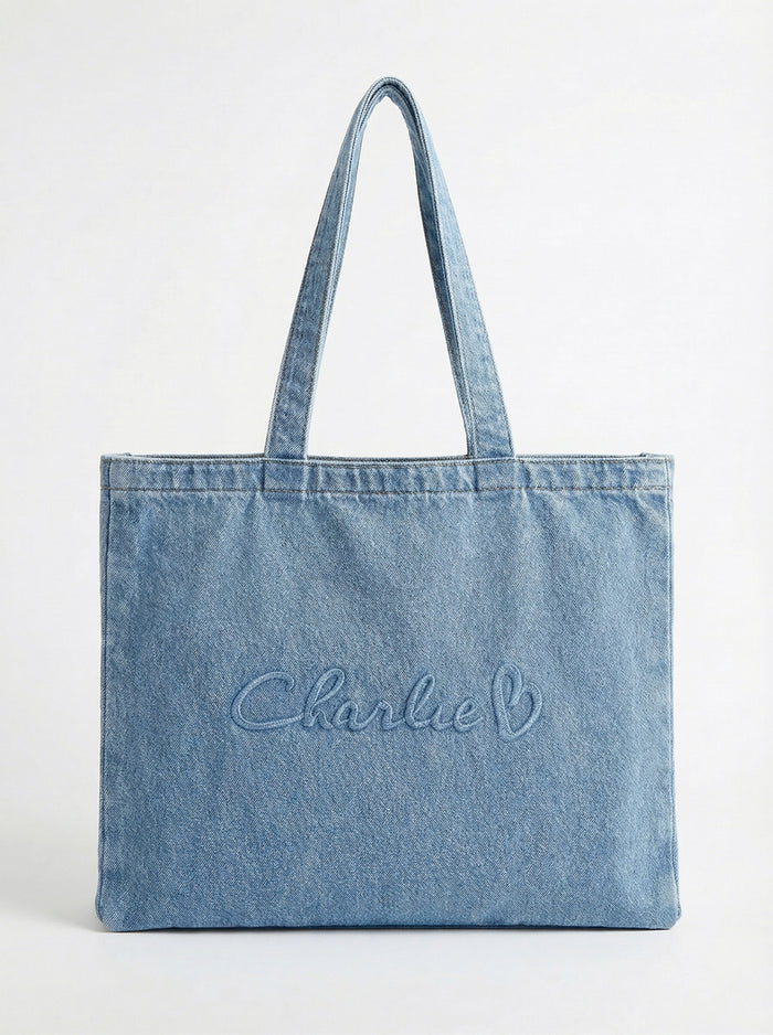 Denim tote bag with comfortable carry handles and a generous handle height of 10 inches. Embossed with the signature logo by Charlie B.