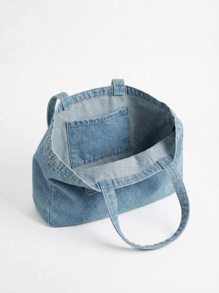 Denim tote bag crafted from 100% cotton, showcasing the embossed Charlie B logo. Features carry handles for easy portability by Charlie B.