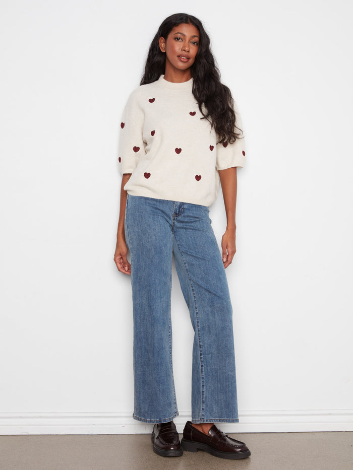 Relaxed fit top featuring delicate heart embroidery on soft fabric, ideal for casual outings. By Charlie B.