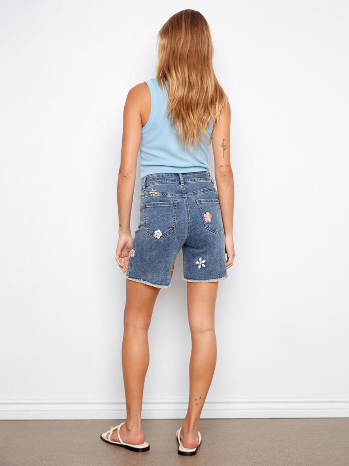 Embroidered denim shorts showcasing a classic five-pocket style, ideal for everyday comfort. By Charlie B.