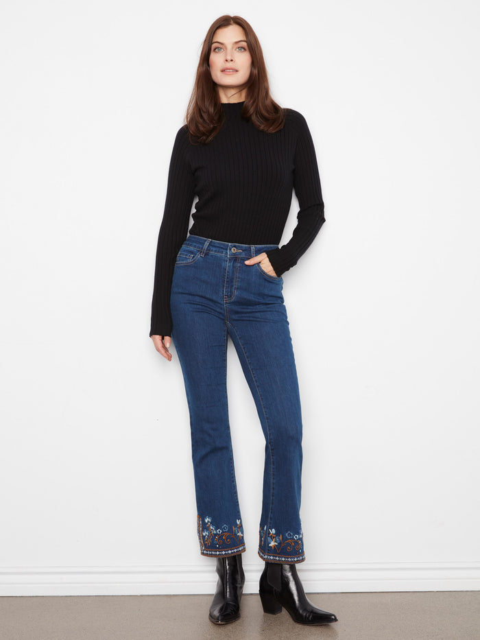 Stretch denim jeans featuring a stylish flare leg design, perfect for versatile wear. By Charlie B.