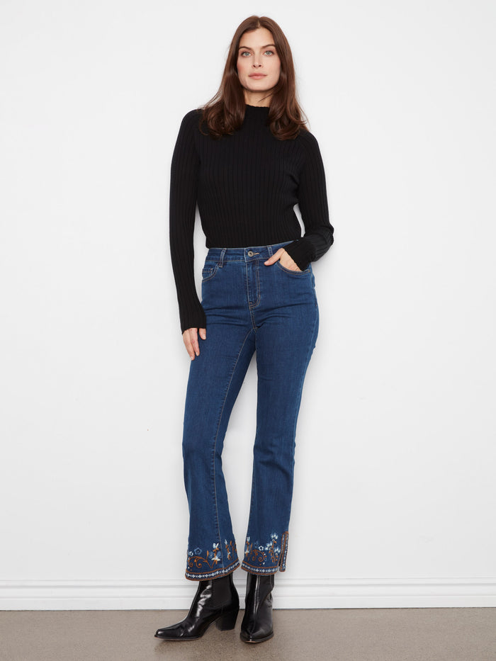 Side slits at the hem enhance the trendy look of these fashionable denim pants. By Charlie B.