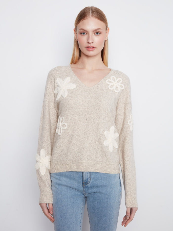 Almond sweater with long sleeves and delicate floral appliqués, perfect for a cozy look by Charlie B.