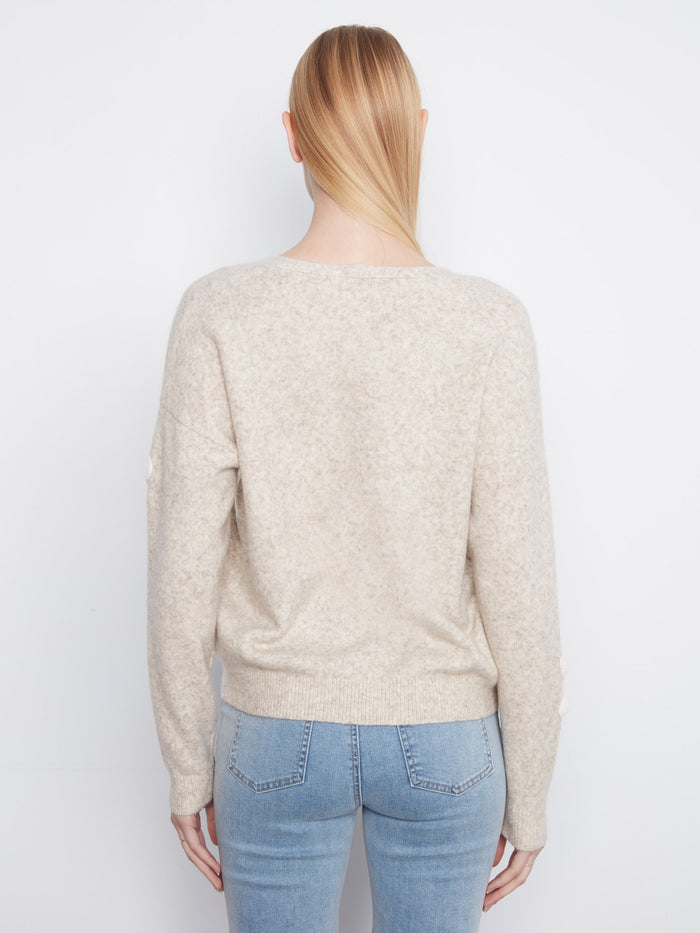 Elegant heather-almond sweater showcasing intricate floral designs for added charm by Charlie B.