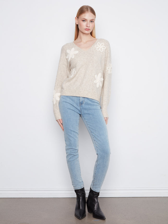 Cozy V-neck sweater in a soft almond shade, adorned with detailed flower appliqués by Charlie B.