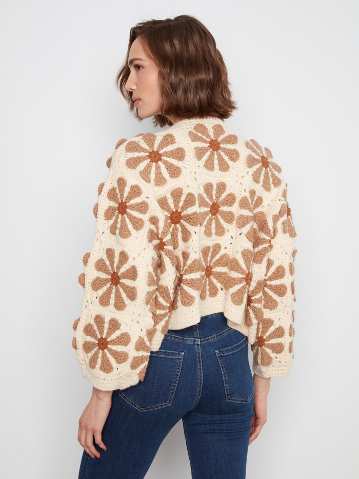 Long-sleeved ecru crochet cardigan showcasing bold floral patterns in a cropped length by Charlie B.