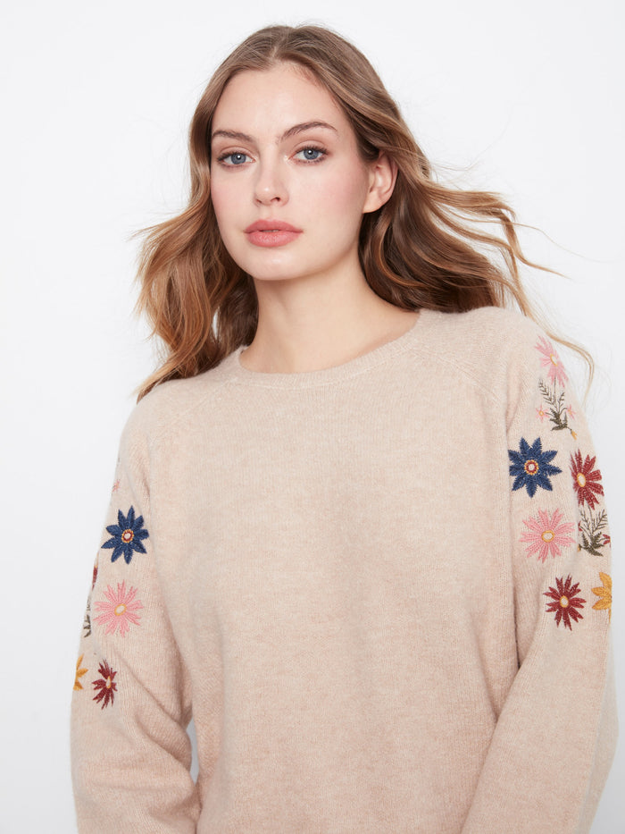 The crew neckline of this sweater ensures timeless appeal while the intricate floral embroidery adds a touch of femininity by Charlie B.