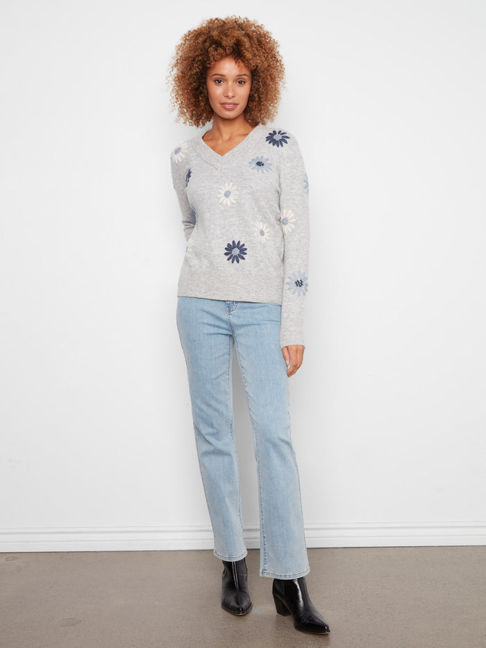 Elegant V-neck sweater with intricate floral embroidery and ribbed hem by Charlie B.