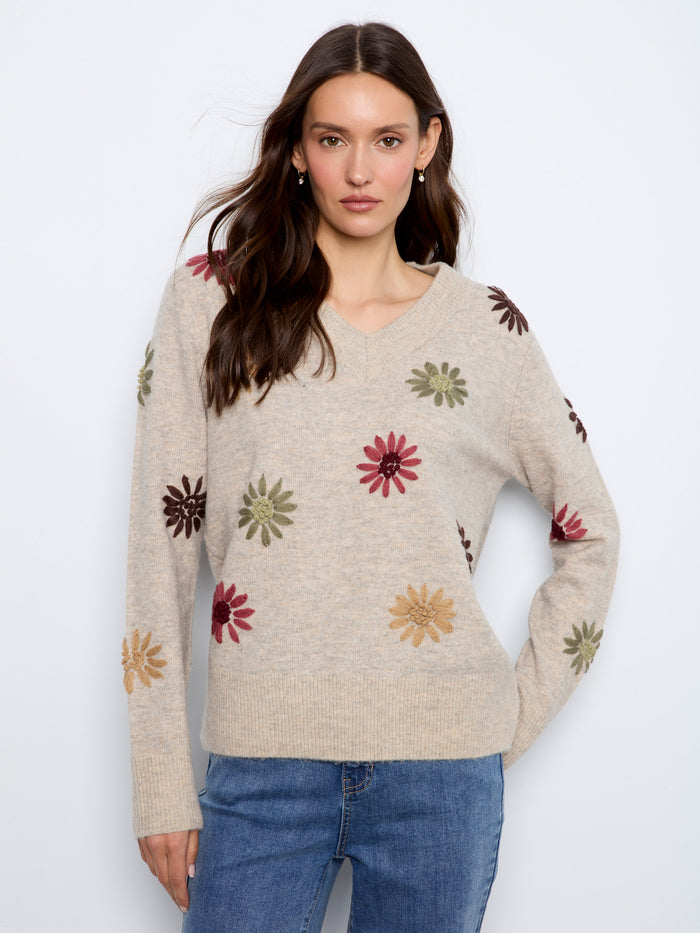 Sweater with a V-neck design, featuring elegant floral embroidery for a touch of charm. Crafted by Charlie B.